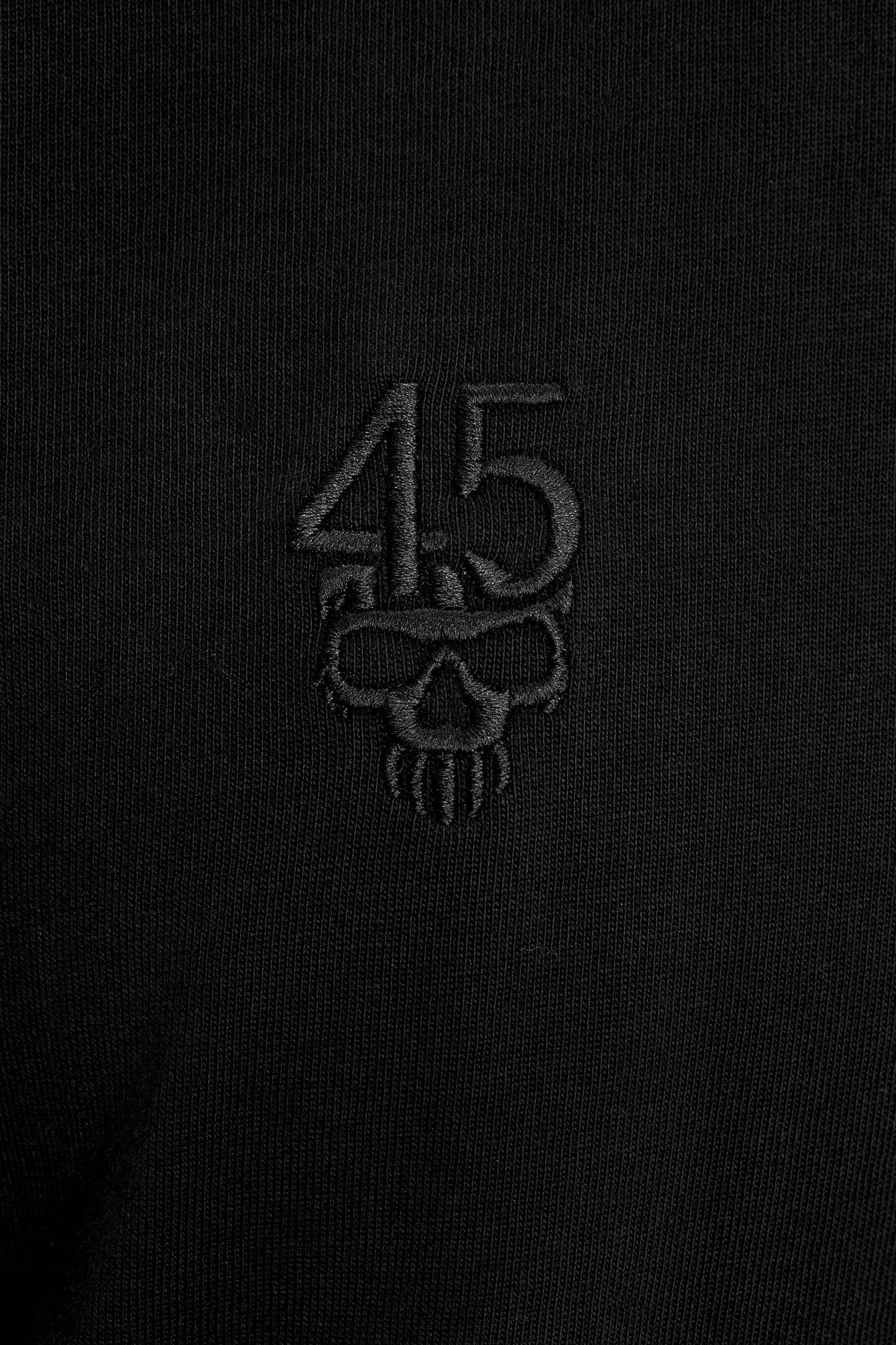 Close-up of tonal 45 skull embroidery on the Forty Five Supply Signature Tee