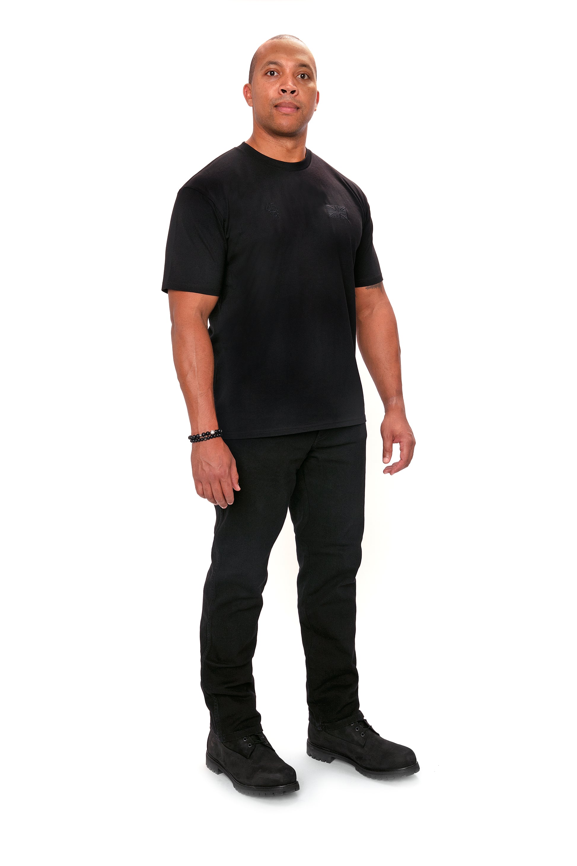 Model wearing the Forty Five Supply Signature Tee in Black in size XL, three-quarter view