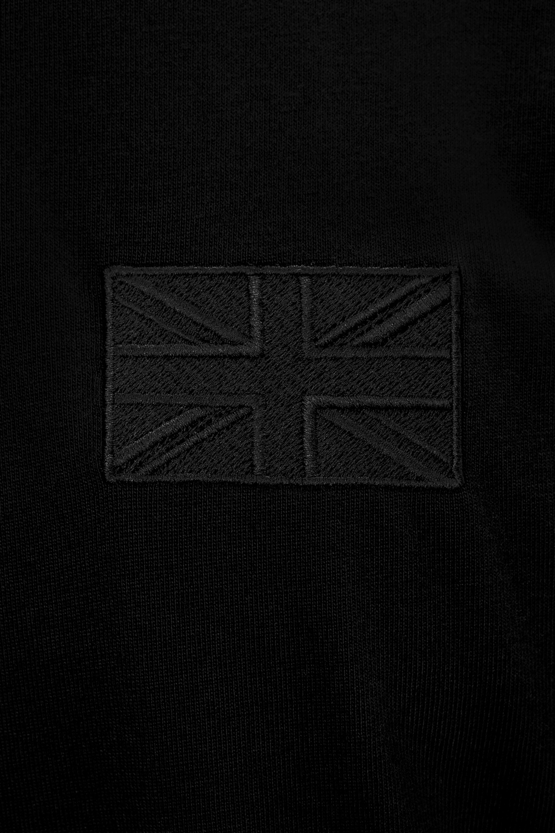 Close-up of tonal Union Flag embroidery on the Forty Five Supply Signature Tee